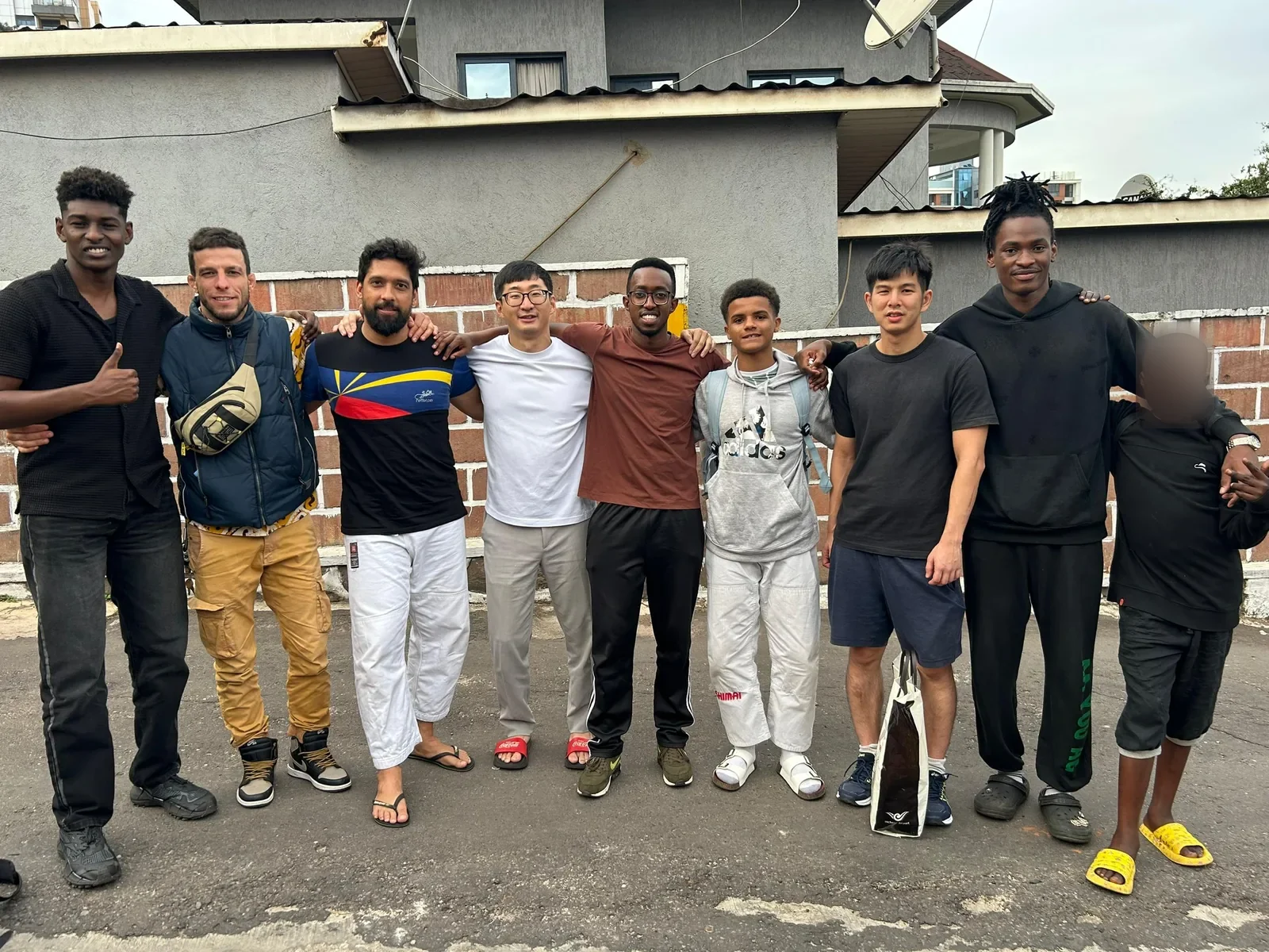 Kigali BJJ teammates standing together outside the gym