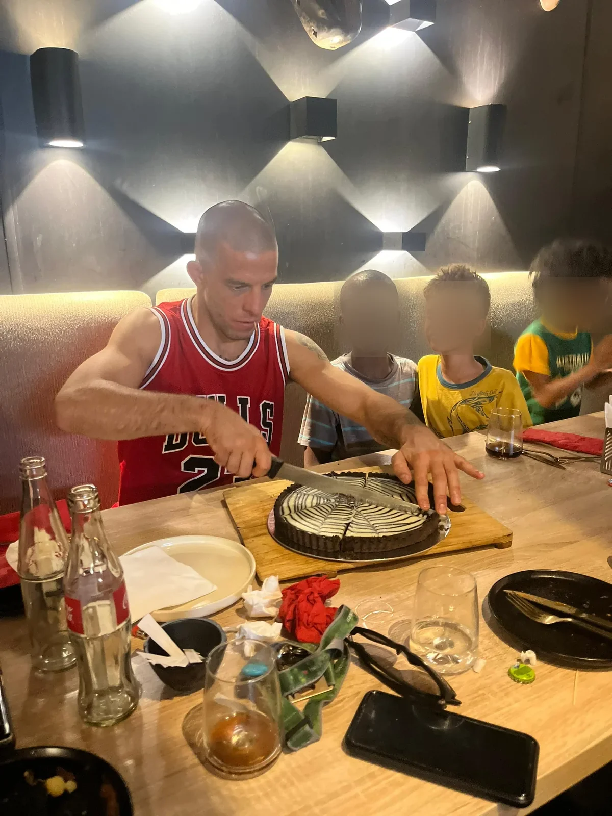 Kigali BJJ teammates cutting a birthday cake