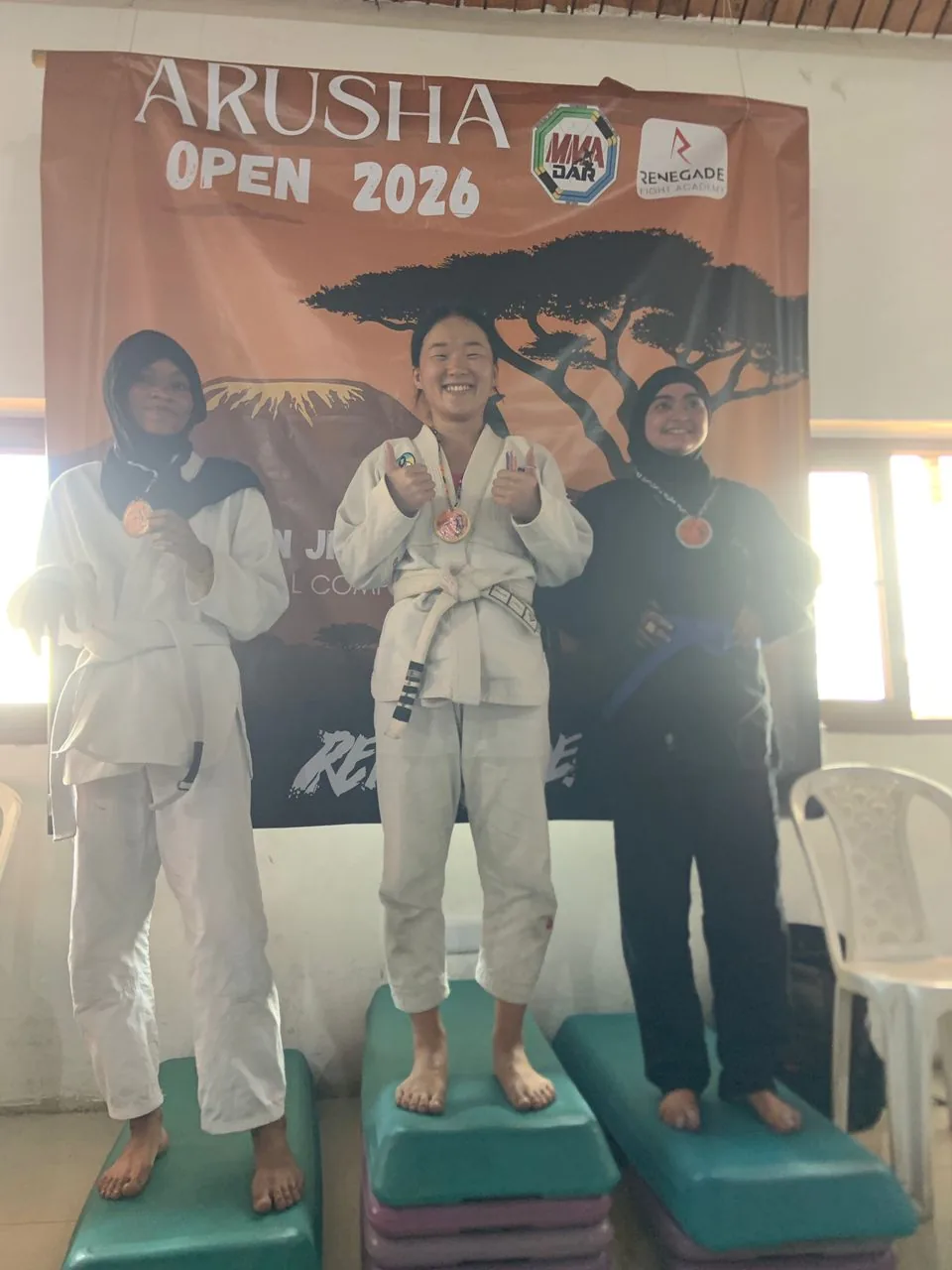 Three women competitors standing on the Arusha Open podium