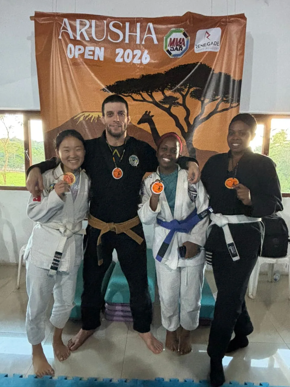 Kigali BJJ team smiling and showing their Arusha Open medals