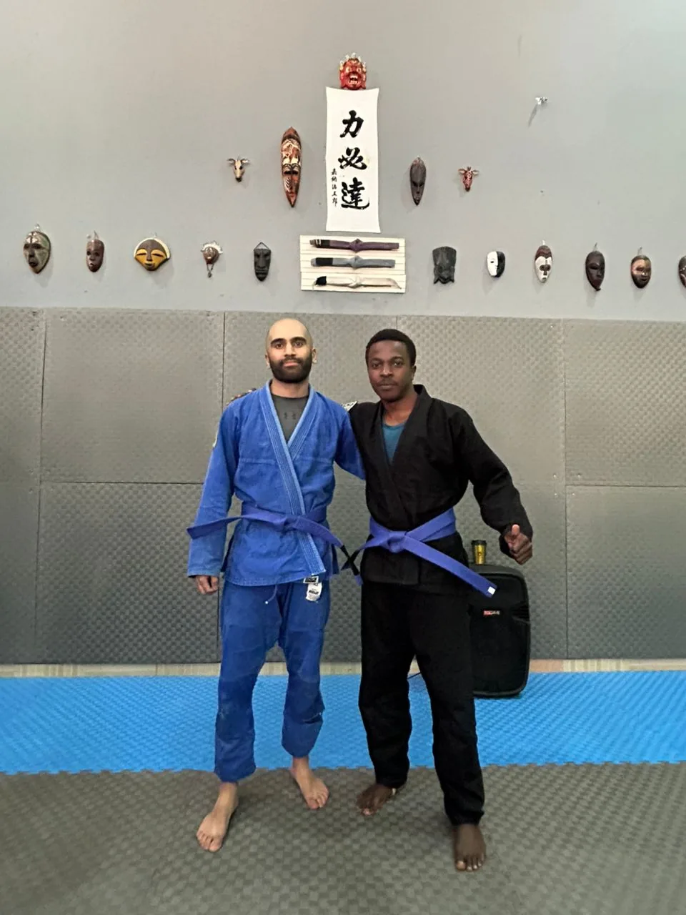 Hannan and Manzi earn their blue belts at Kigali BJJ