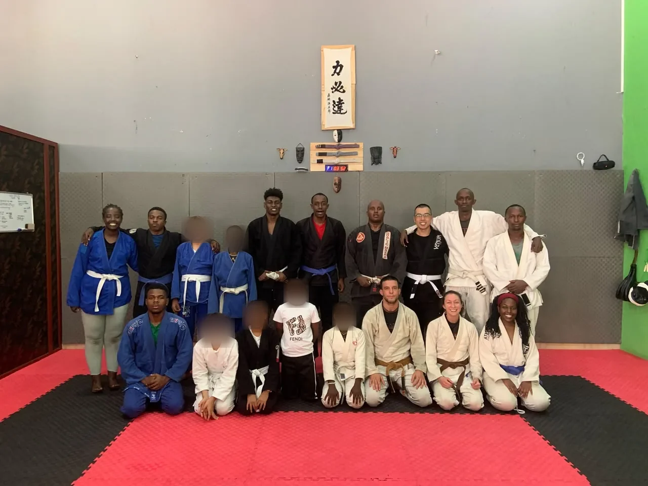 Kigali BJJ students in blue, white, and black gis