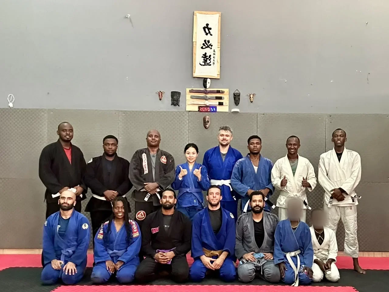 Kigali BJJ students posing in two rows after class