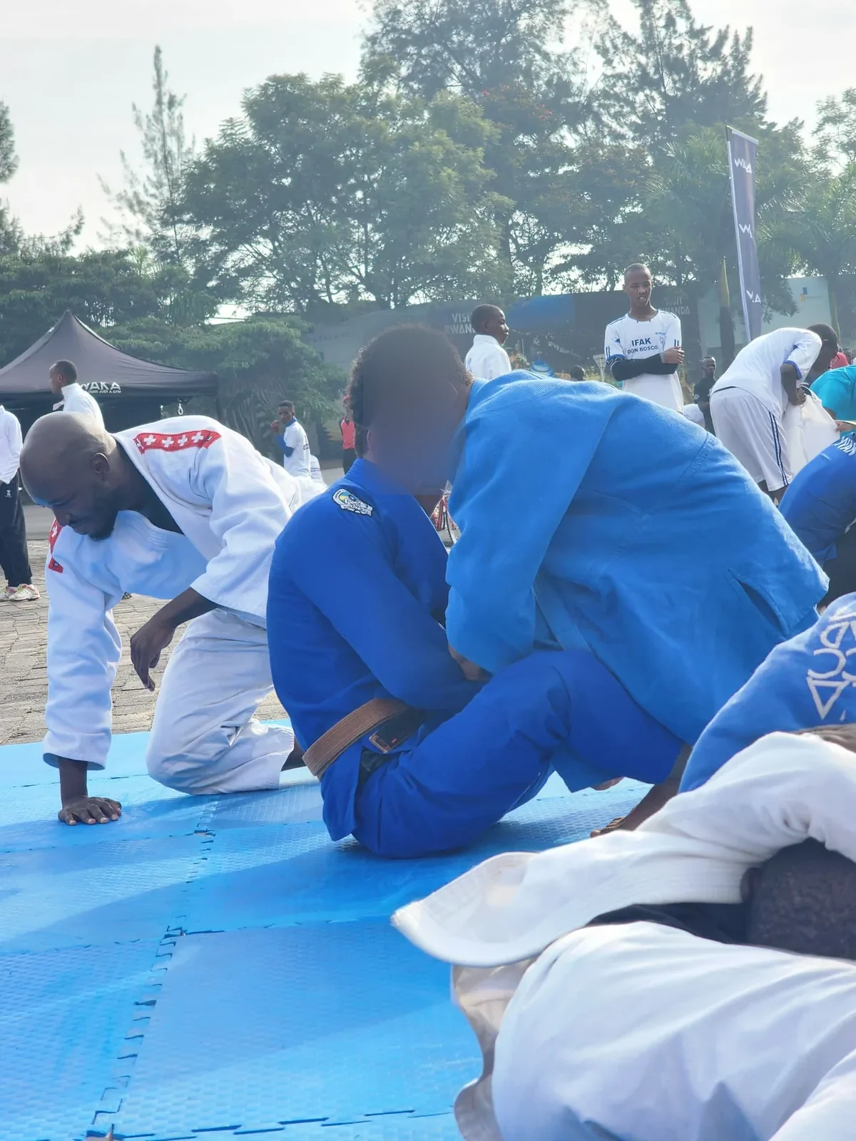 Kigali BJJ athletes demonstrating grappling outdoors