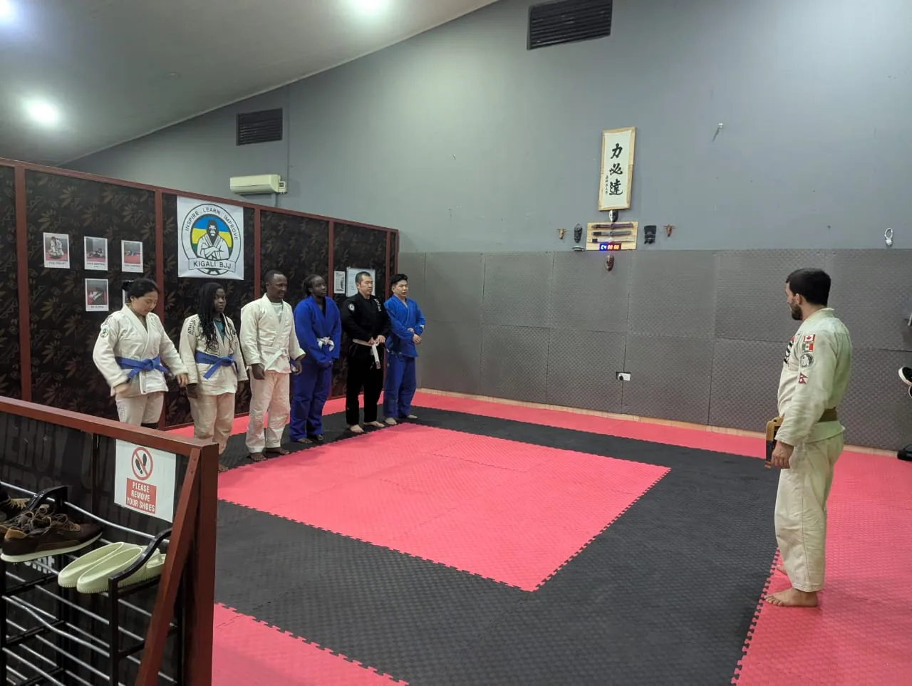 Gi students standing at the edge of the mat during class