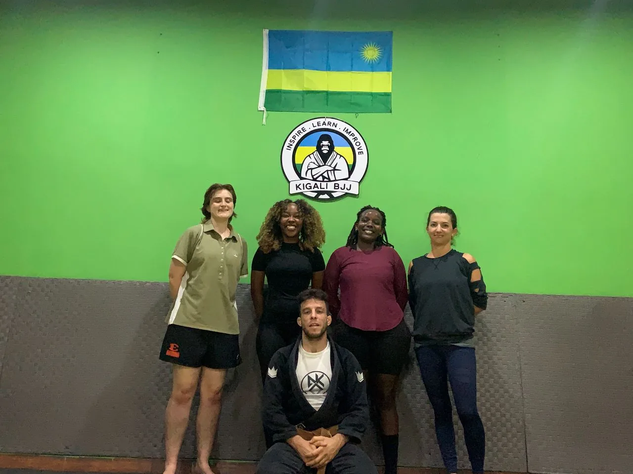 Kigali BJJ women’s class posing by the team logo